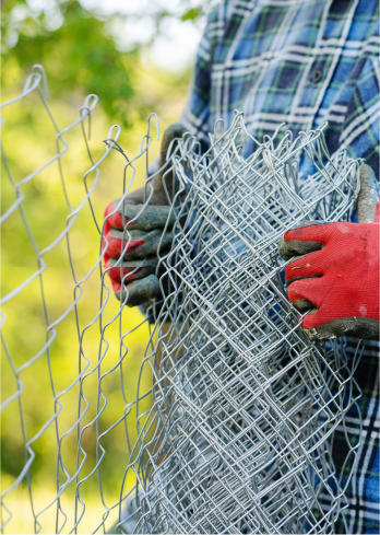man laying down wire fence